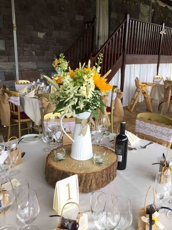 Wedding Table floral display on log on table