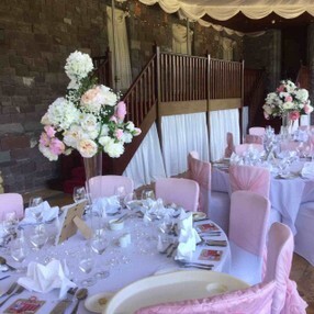 pink and white wedding decor chair covers and flowers