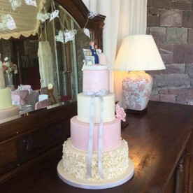 Wedding cake on sideboard in Craig y Nos Castle Conservatory