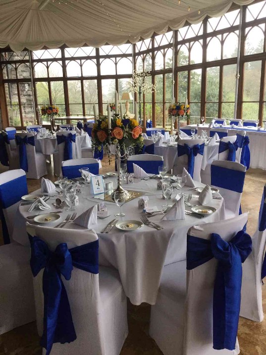 Marriage Venue Wales Craig y Nos Castle Conservatory blue sashes