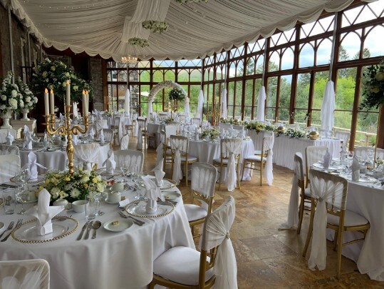 Craig y Nos Castle Wedding Venue Swansea Conservatory Wedding Breakfast pale yellow ribboned chair covers