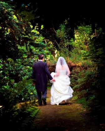 Bride and Groom walking in Craig y Nos Country Park