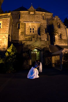 Bride and groom in front of Craig y Nos Castle Wedding Venue at night