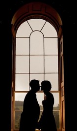 Chris Barroccu Wedding Photographer Bride and Groom in front of large window