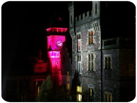 Wedding Venues in Wales, Craig y Nos Castle at night - clocktower pink floodlit for Halloween