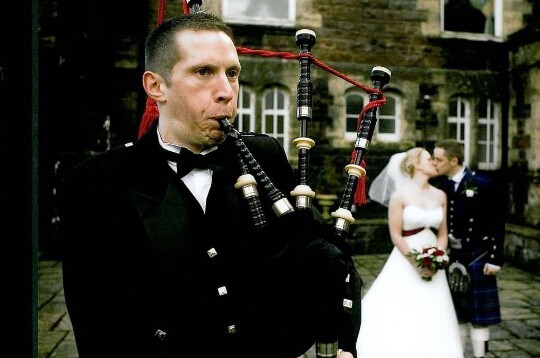 Wedding Planner Guide, Bagpiper on theatre terrace at Craig y Nos Castle and wedding couple