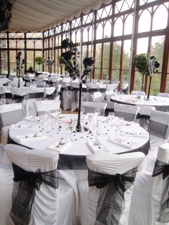 South Wales Wedding Venue Craig y Nos Castle Conservatory Black and White Chair covers and Tables