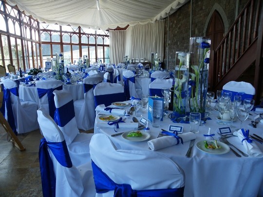Craig y Nos Castle Swansea the Conservatory tables laid up with Blue and white chair covers and blue flowers