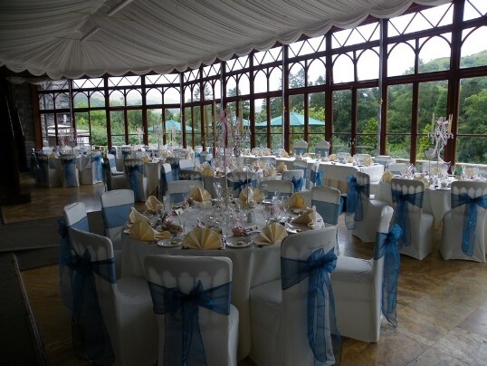 Craig y Nos Castle Wedding Venue Conservatory blue ribbons on white chair covers 