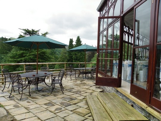 Craig y Nos Castle Wedding Venue in South Wales showing the Conservatory terrace and garden tables