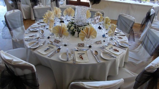 A table laid up for a wedding breakfast at Craig y Nos Castle's Conservatory mainly in white