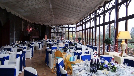 Craig y Nos Castle Wedding Venue the Conservatory set up for a wedding breakfast, blue and white theme