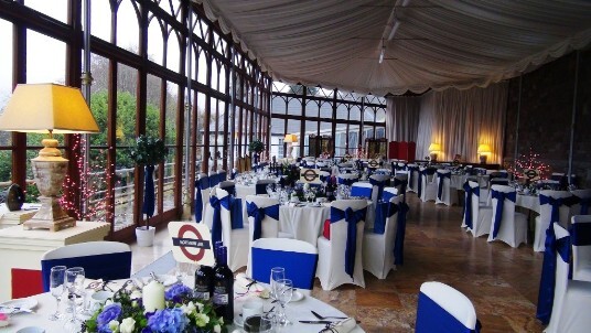 Craig y Nos Castle Wedding Venue with the Conservatory set up for a wedding breakfast blue and white