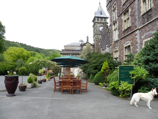 Craig y Nos Castle Wedding Venue in South Wales Front Courtyard showing clock tower and garden tables and chairs