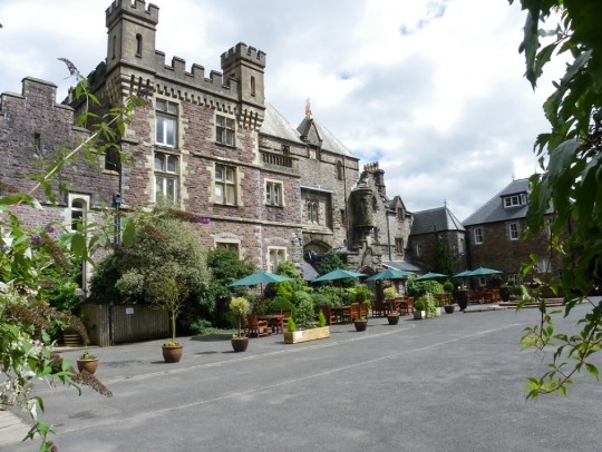Craig y Nos Castle Wedding Venue Swansea Front facade of castle with potted plants and tables and chairs