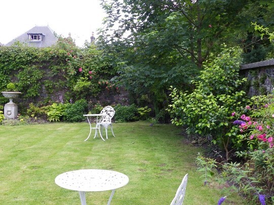 Craig y Nos Castle Wedding Venue flat lawn and flower beds in the walled off Theatre Gardens