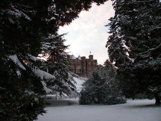 Craig y Nos Castle overlooking snow covered lower gardens and snow covered trees