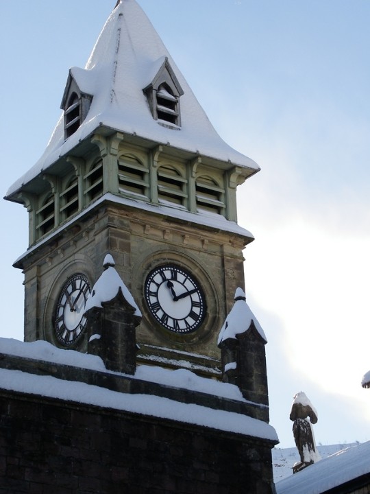clocktower covered in snow at Craig y Nos Castle South Wales