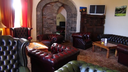 Craig y Nos Castle Wedding Venue Reception Lounge with leather chesterfield sofas and chairs