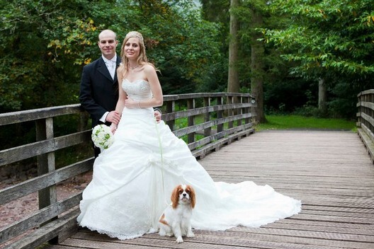 Craig y Nos Castle Wedding Venue accepts dogs couple shown with their dog on Country Park bridge