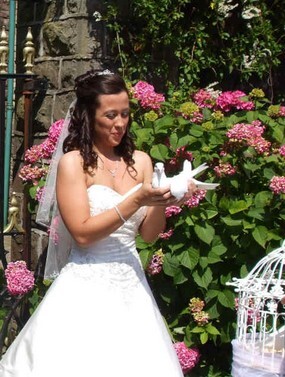 Bride releases dove outside theatre at Craig y Nos Castle