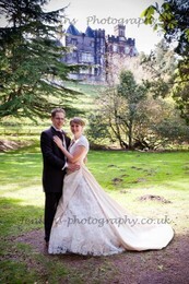 Bridal Couple in lower gardens with backdrop of Craig y Nos Castle